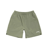 Green shorts with a brand logo on a white background