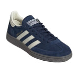 Blue Adidas sneaker with white stripes on a light gray background