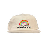 Beige cap with rainbow and text