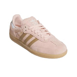 Pink Adidas sneaker with brown sole on a light gray background