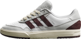 White and brown sneaker with Adidas logo on a white background